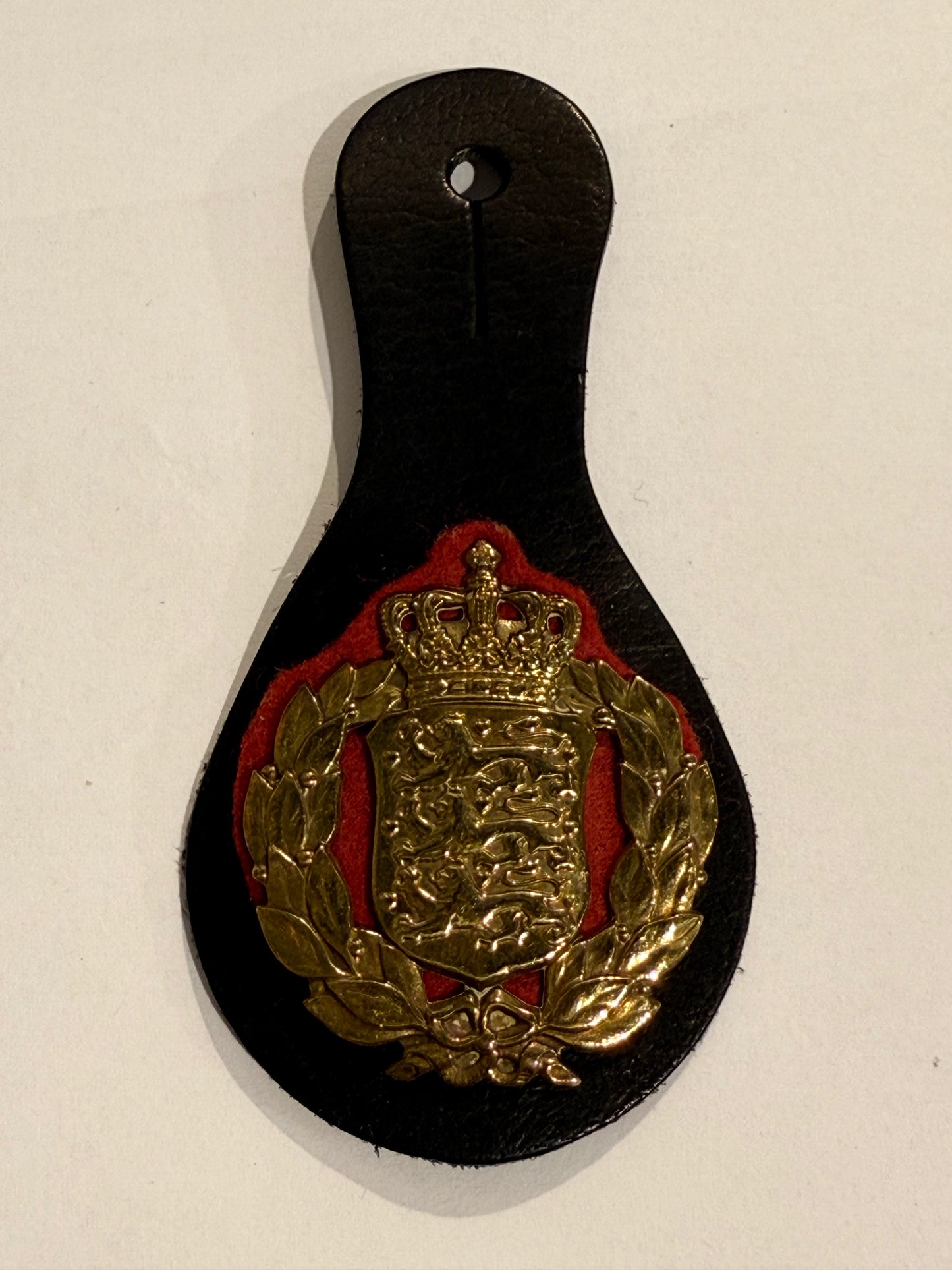 Older Danish Army Badge in gilded brass, with leather buttonhole holder.