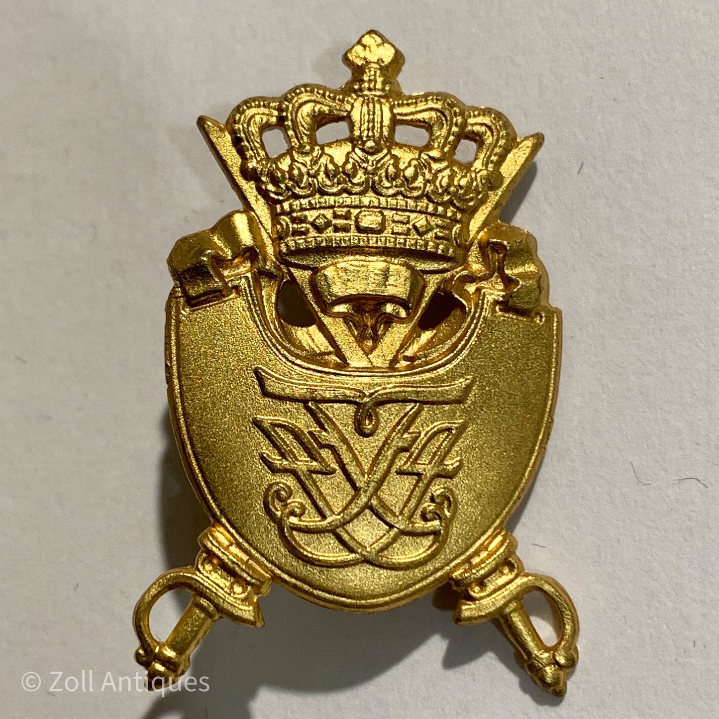 Hærens officerskole mærke er et guld-emaljeret mærke, der viser en krona og en sol. Mærket er udformet som et kors og er et symbol