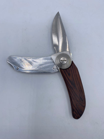 Folding knife after Barry Woods design in stainless steel and wood.