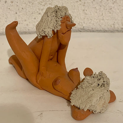 Vintage stoneware caricature figurine of loving couple.