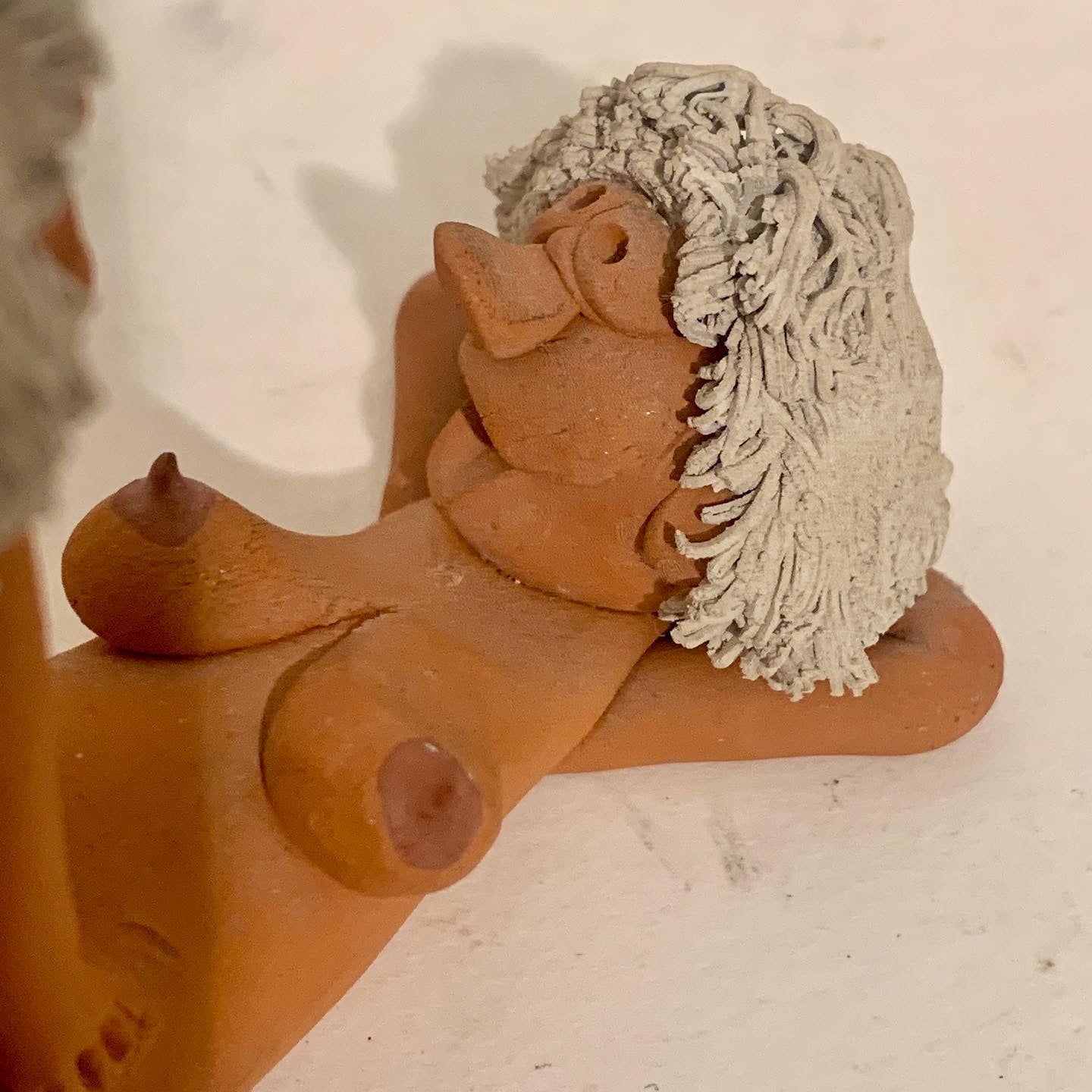 Vintage stoneware caricature figurine of loving couple.