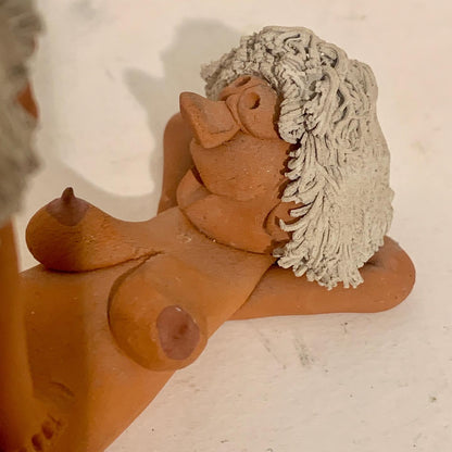 Vintage stoneware caricature figurine of loving couple.