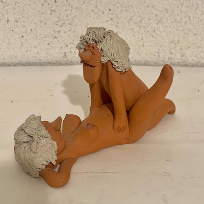 Vintage stoneware caricature figurine of loving couple.
