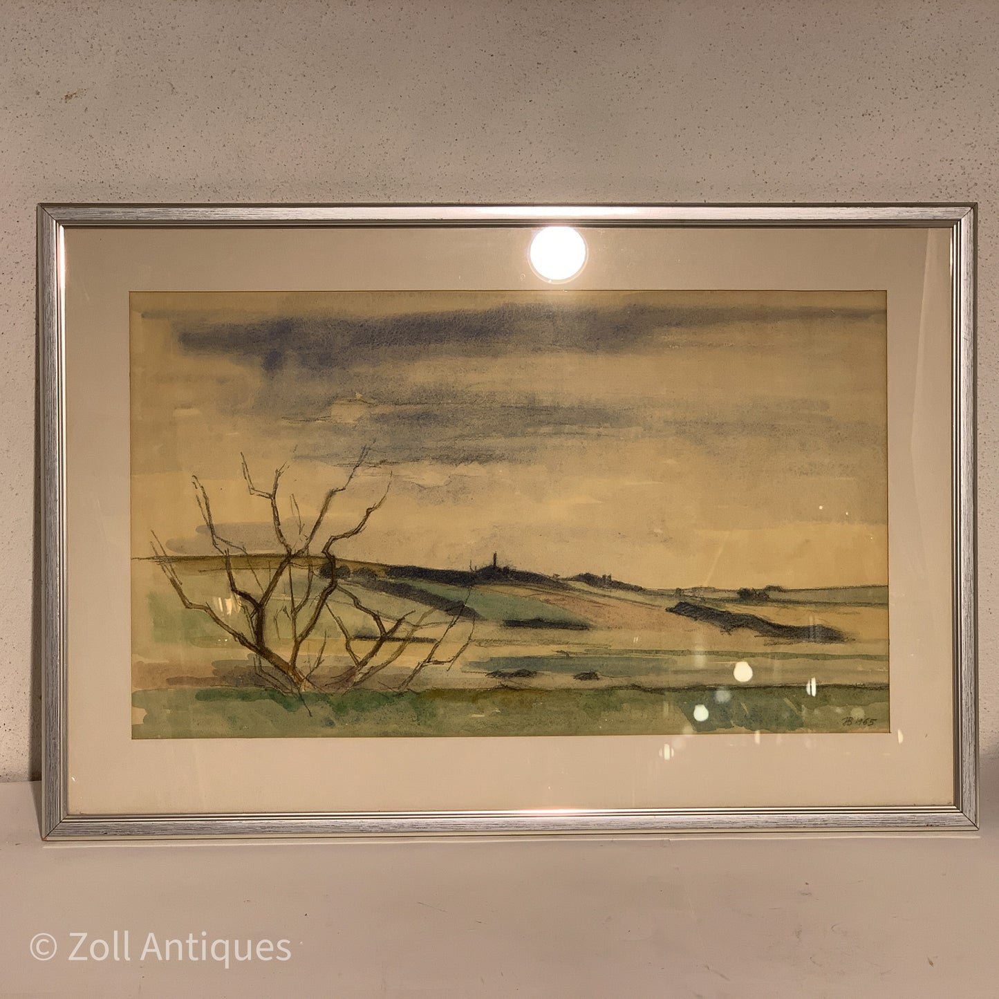 Johannes Bæch's 1965 watercolor painting is displayed in a silver frame. The painting features a tree and a mountain landscape, cr